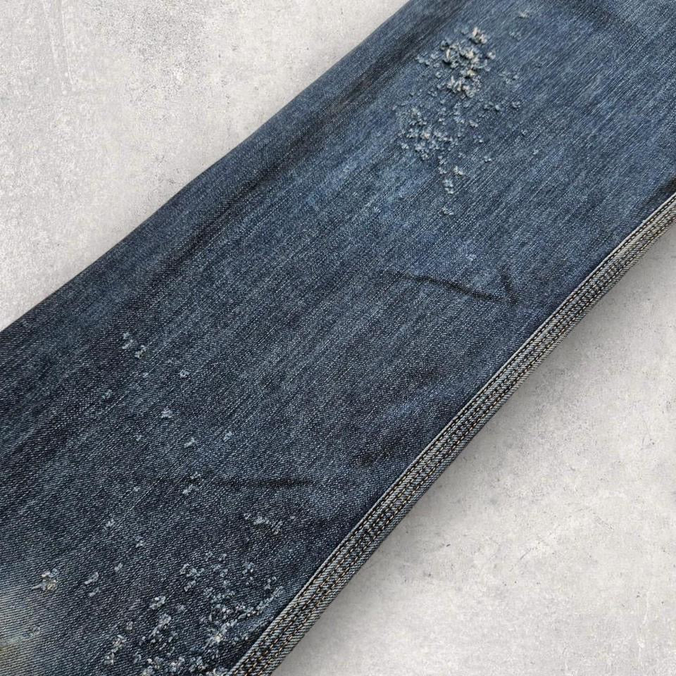 Carhartt navy workwear jeans with distressed bottom and relaxed fit