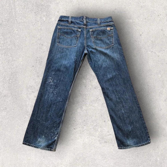 Carhartt navy workwear jeans with distressed bottom and relaxed fit