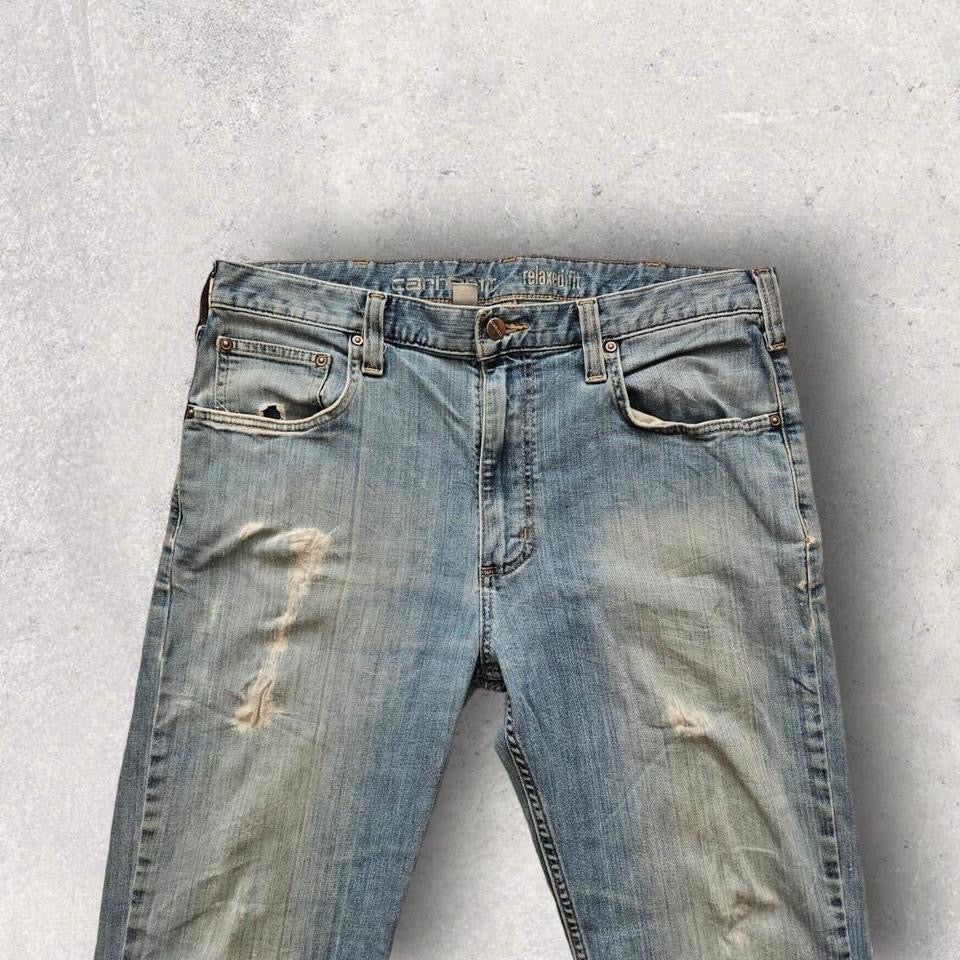 Carhartt blue jeans in relaxed fit, featuring unique vintage distressing and wear, size 36x32.