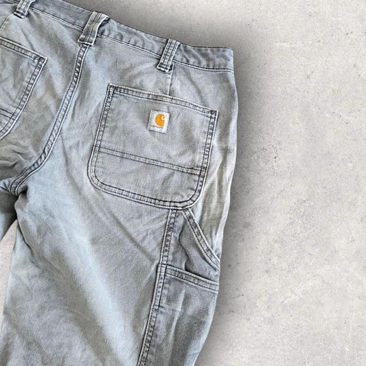 Carhartt grey carpenters pants with ripped front and distressed marks