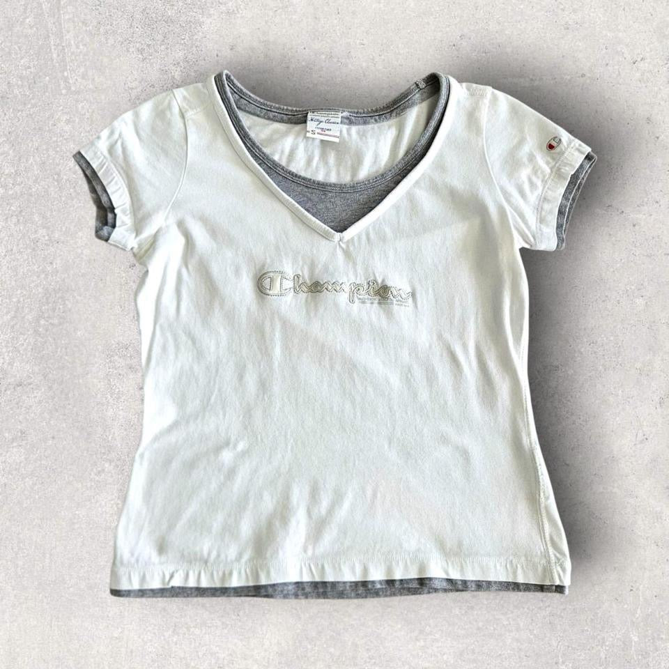 Vintage Champion Woman’s White T-shirt - S T-Shirts 65.00 NIS Vintage Champion Woman’s White T-shirt - S Lizard Vintage Clothes
