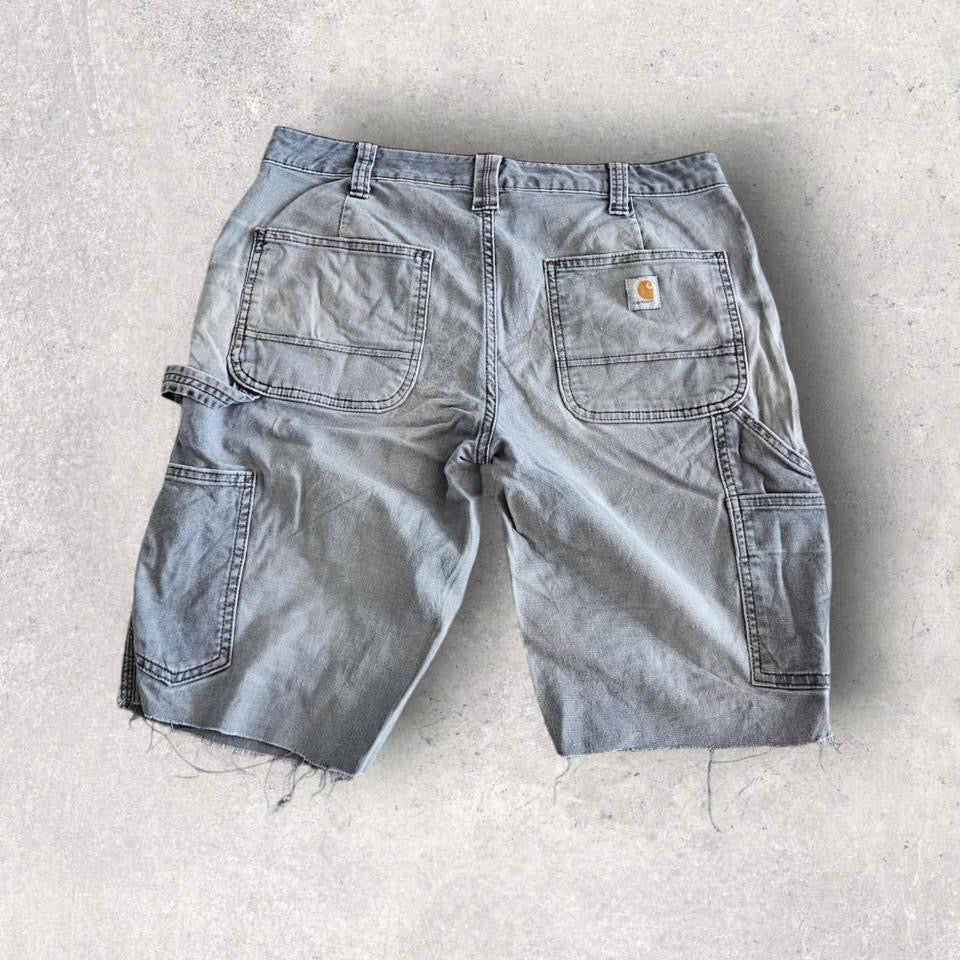 Carhartt grey carpenters pants with ripped front and distressed marks