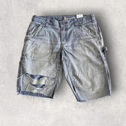 Carhartt grey carpenters pants with ripped front and distressed marks