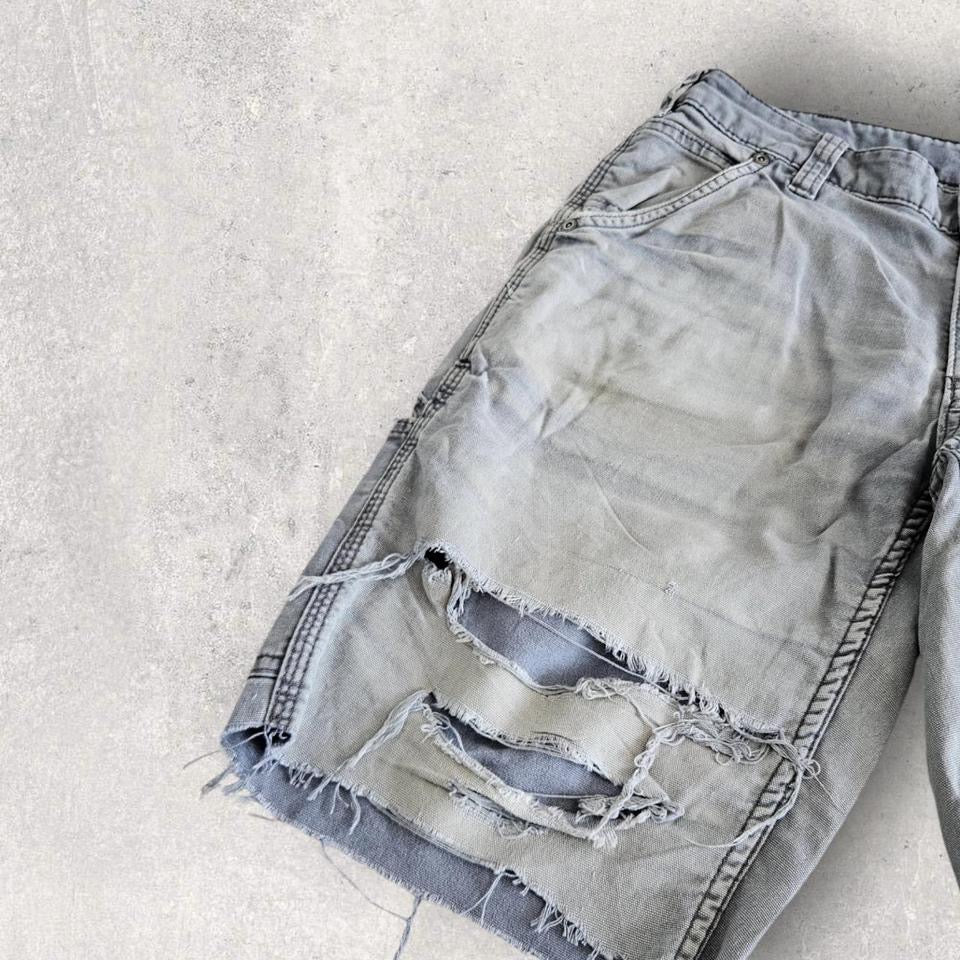 Carhartt grey carpenters pants with ripped front and distressed marks