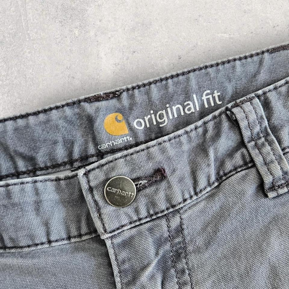 Carhartt grey carpenters pants with ripped front and distressed marks