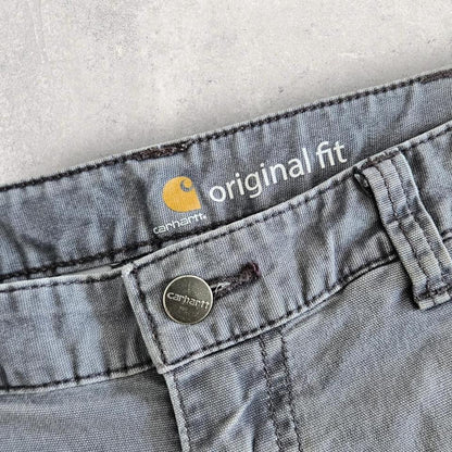 Carhartt grey carpenters pants with ripped front and distressed marks